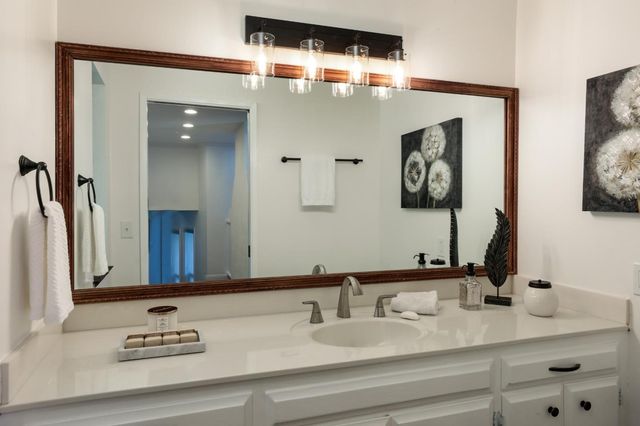 a bathroom with double vanity sinks and a mirror