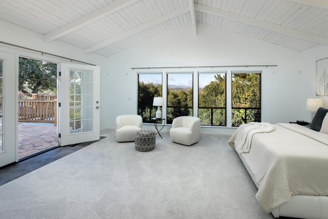 a bedroom with bed and glass door