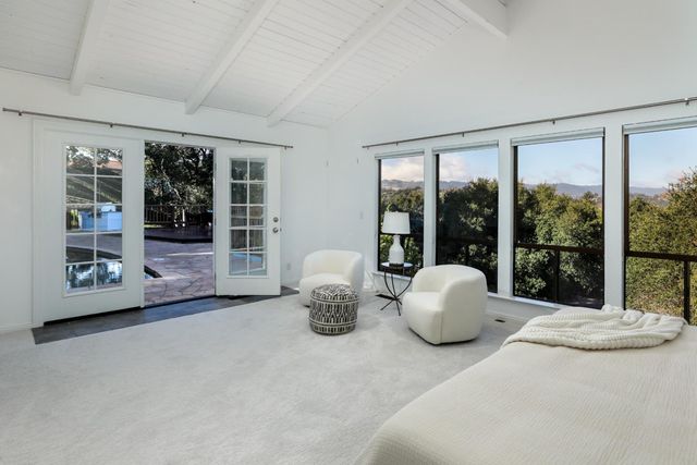 a room with furniture and large windows