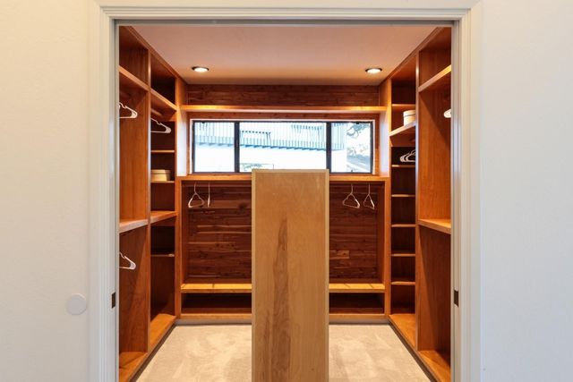 a view of walk in closet with empty racks