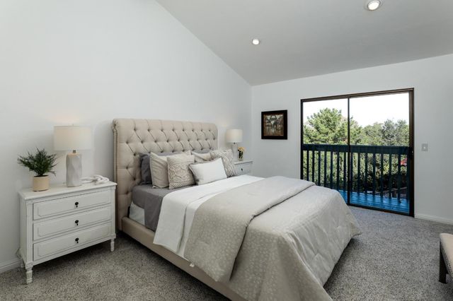 a bedroom with a large bed and a tv on a dresser