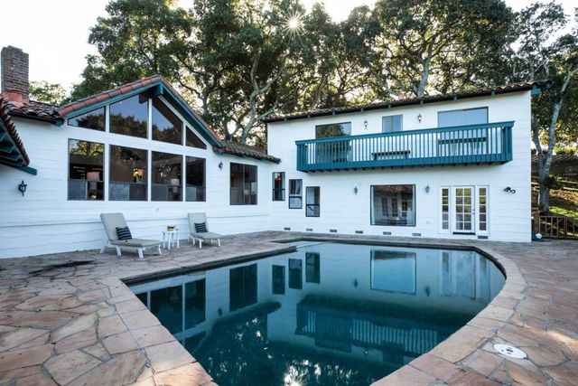 a view of a chairs and table in the balcony