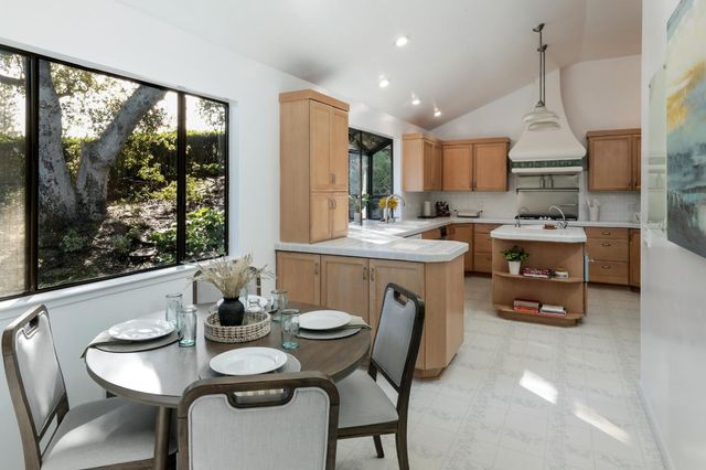 a kitchen with a table chairs and wooden floor