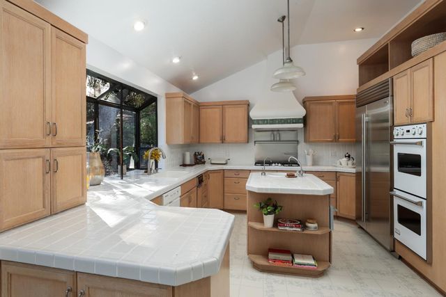 a kitchen with a sink appliances and cabinets