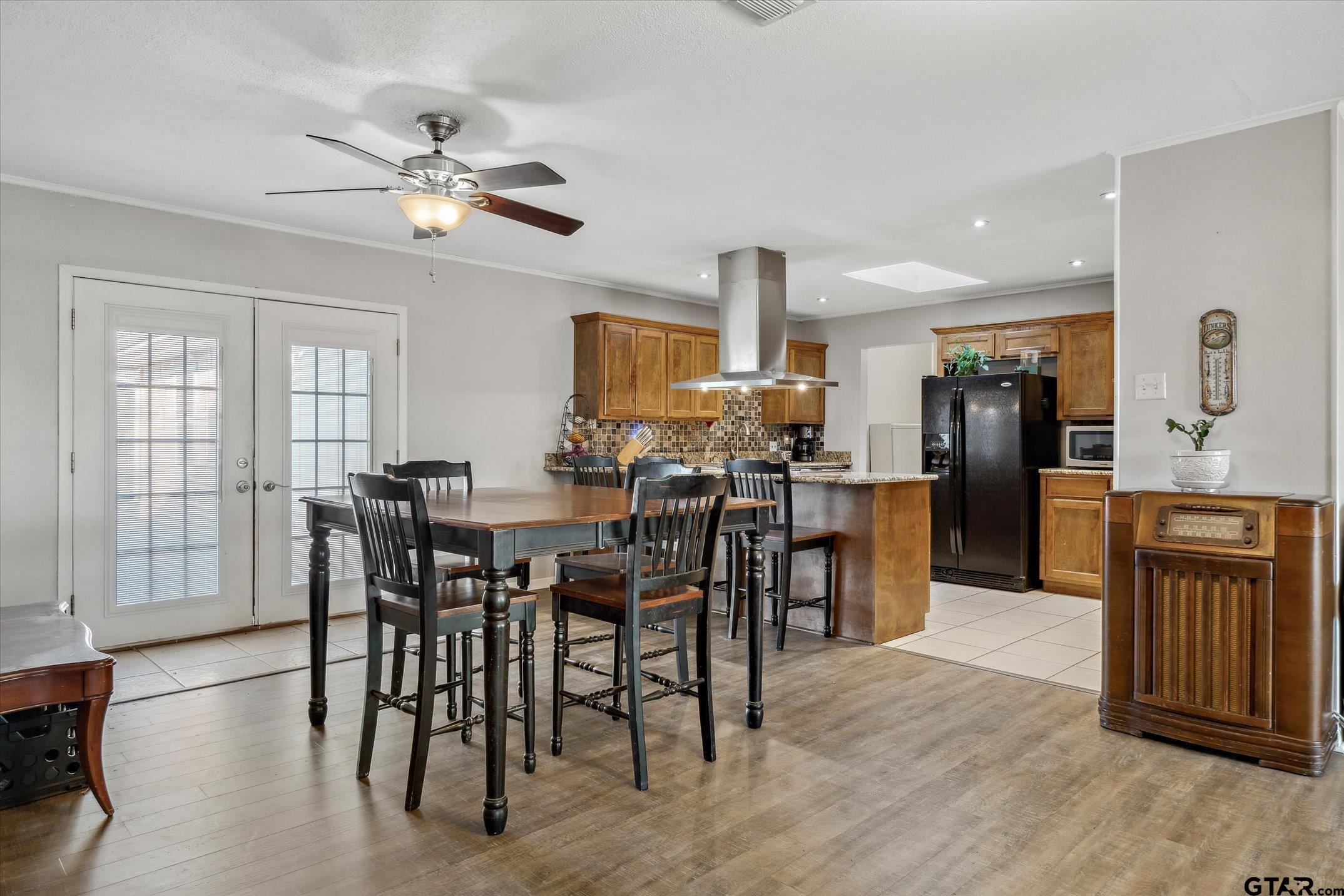 542 South Houston Street Edgewood, TX 75117 - Photo 15 of 37 a view of a dining room with furniture and wooden floor
