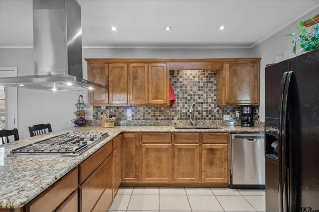 a kitchen with stainless steel appliances granite countertop a sink stove and refrigerator