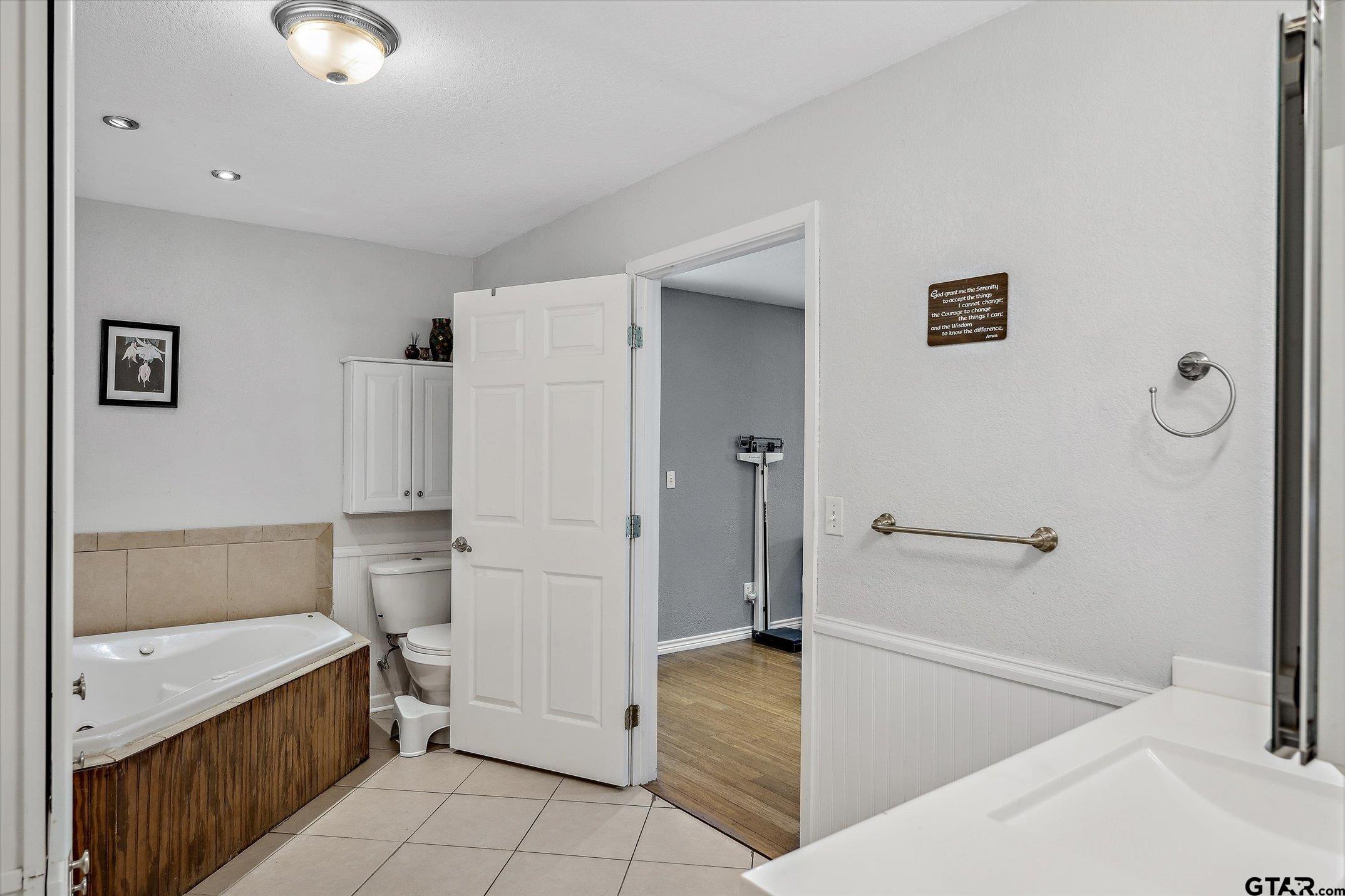 542 South Houston Street Edgewood, TX 75117 - Photo 29 of 37 a bathroom with a tub sink and a mirror