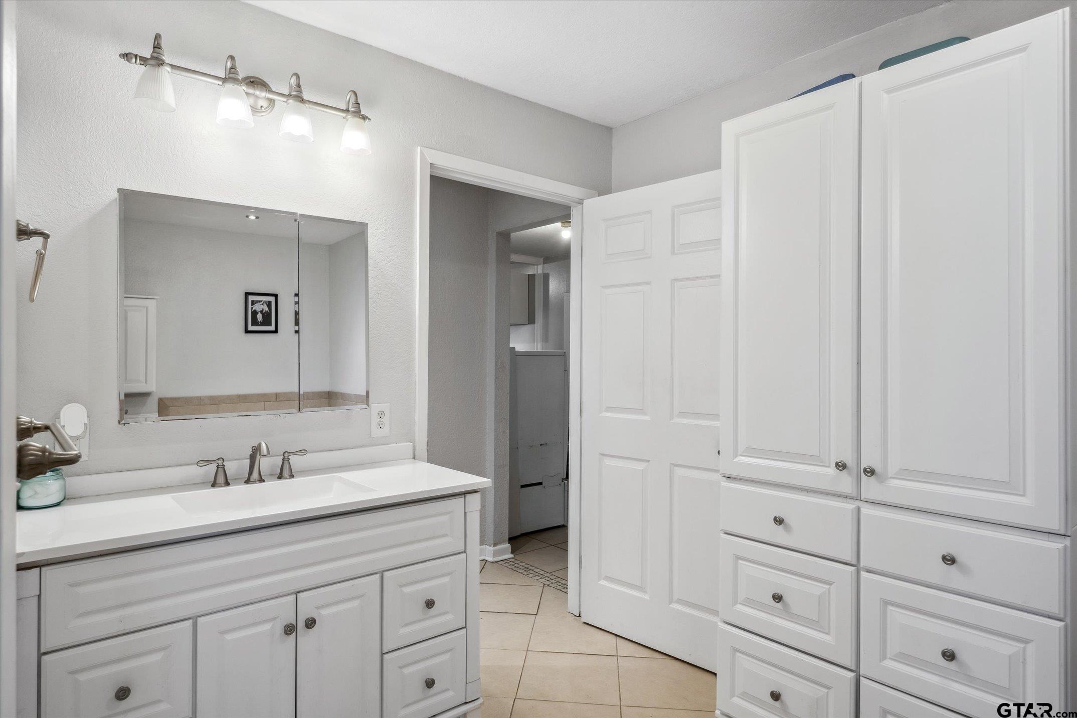542 South Houston Street Edgewood, TX 75117 - Photo 31 of 37 a bathroom with a double vanity sink and mirror