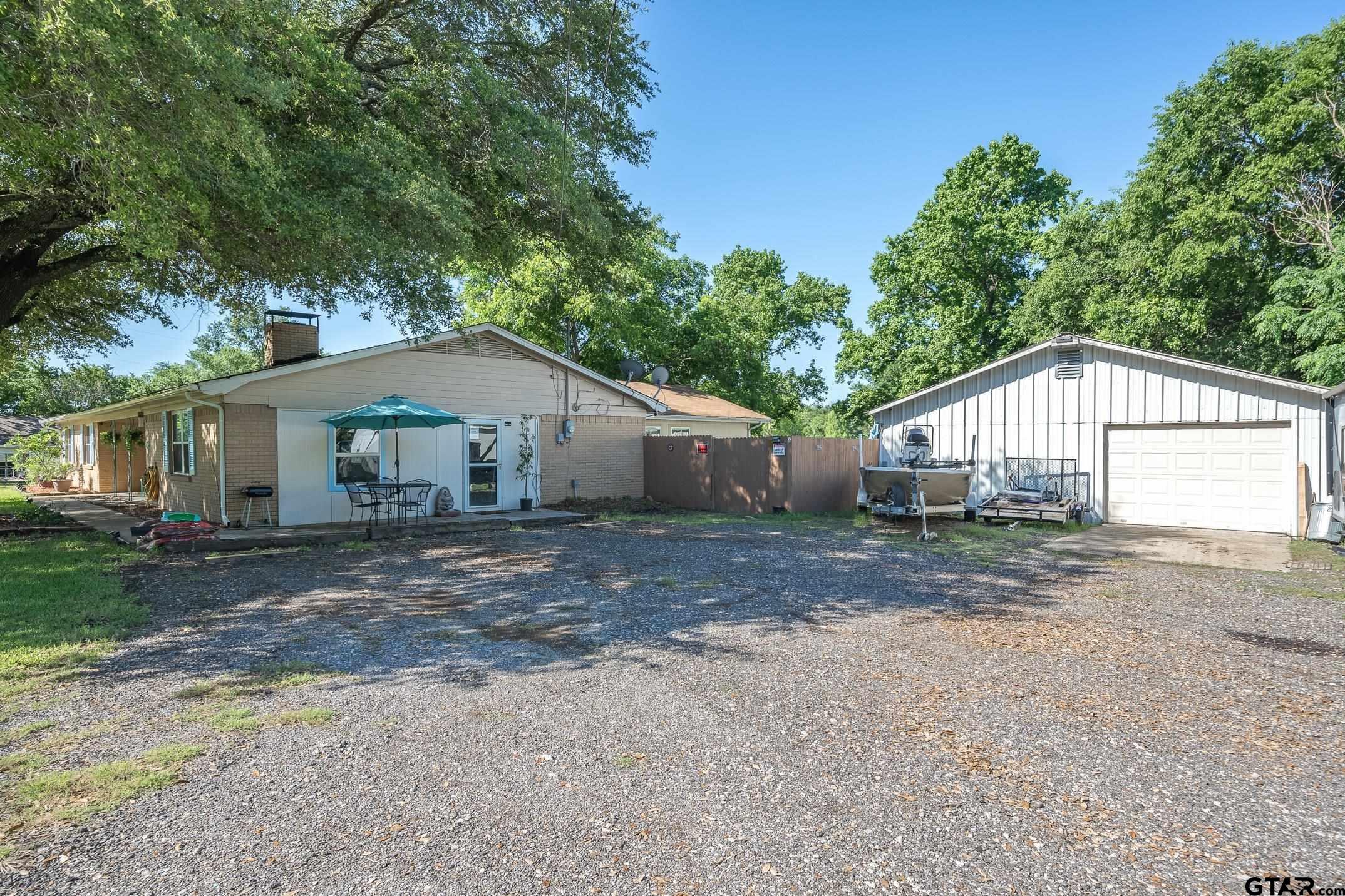 542 South Houston Street Edgewood, TX 75117 - Photo 7 of 37 a front view of a house with a yard and garage