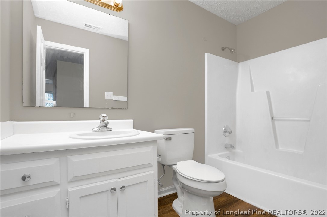 512 Andover Road Fayetteville, NC 28311 - Photo 14 of 18 a bathroom with a sink toilet vanity and tub