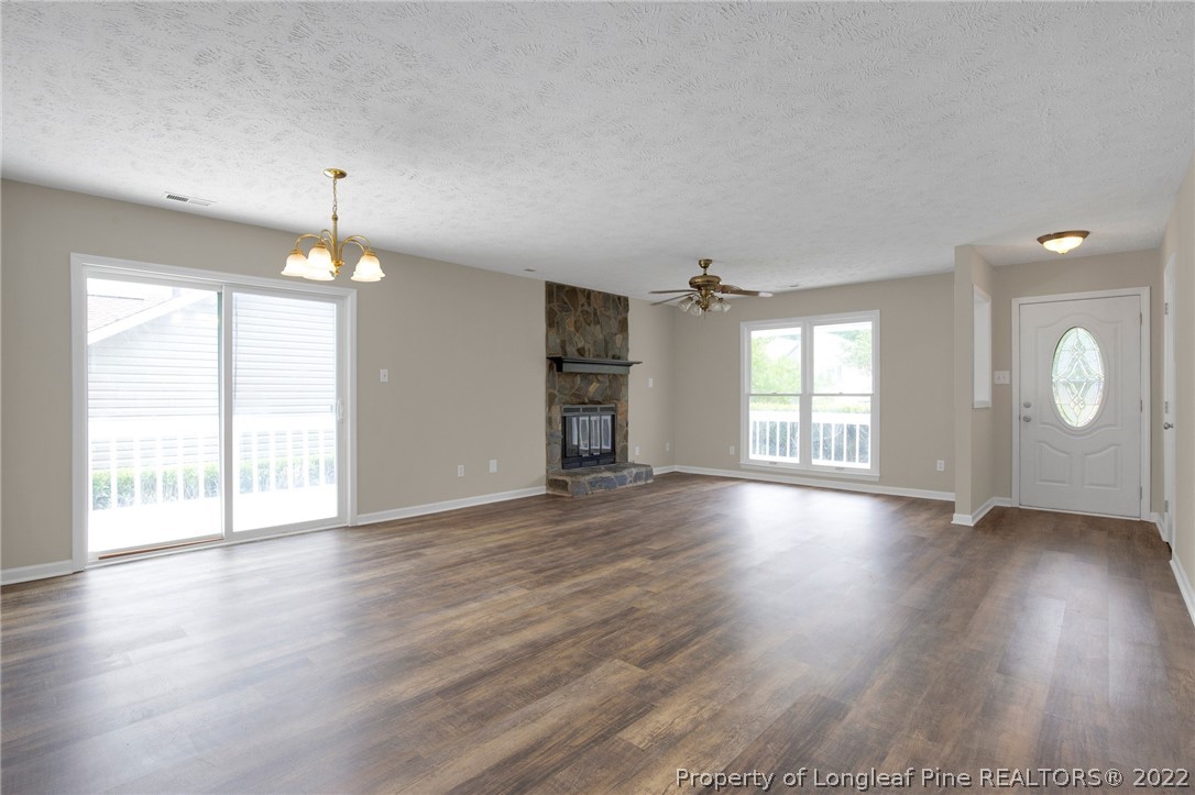 512 Andover Road Fayetteville, NC 28311 - Photo 4 of 18 an empty room with wooden floor and windows