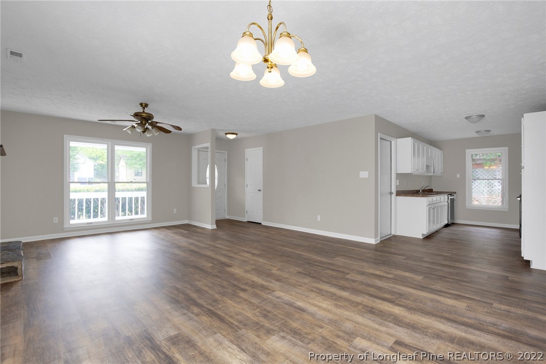 512 Andover Road Fayetteville, NC 28311 - Photo 5 of 18 a view of an empty room with wooden floor and a window