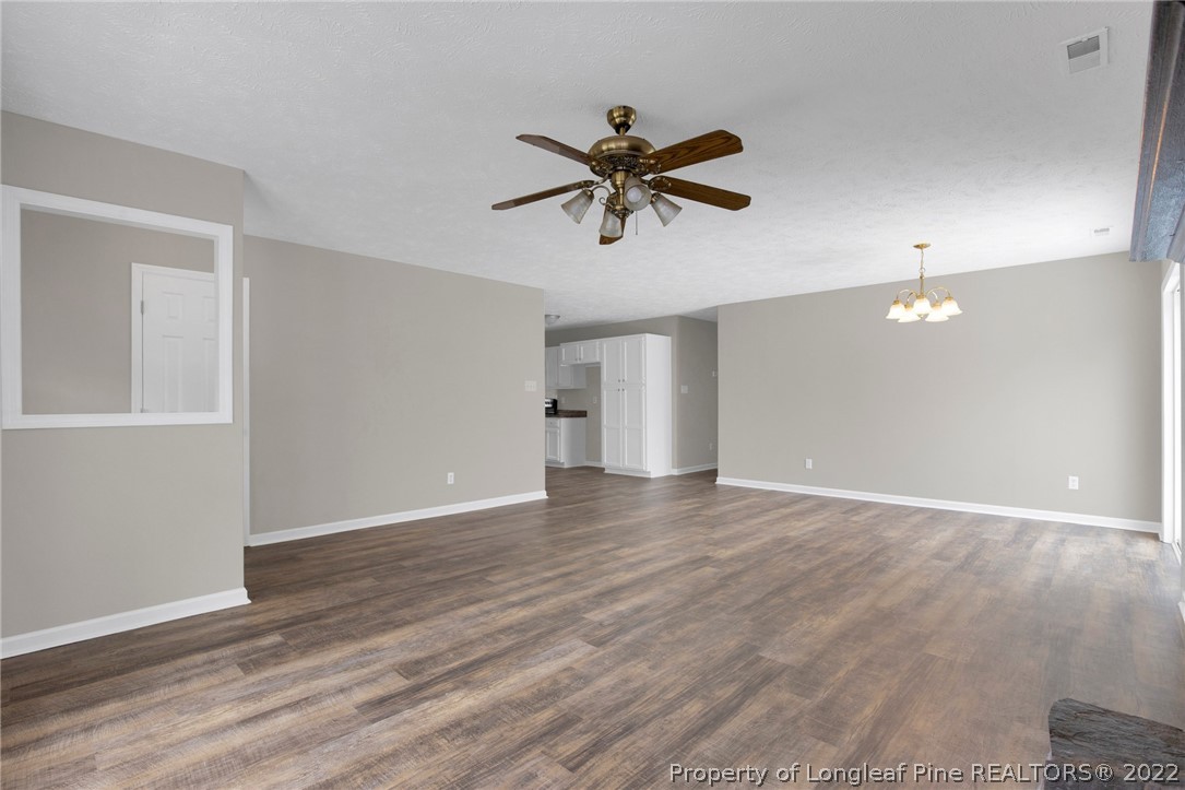 512 Andover Road Fayetteville, NC 28311 - Photo 6 of 18 a view of empty room with wooden floor and ceiling fan