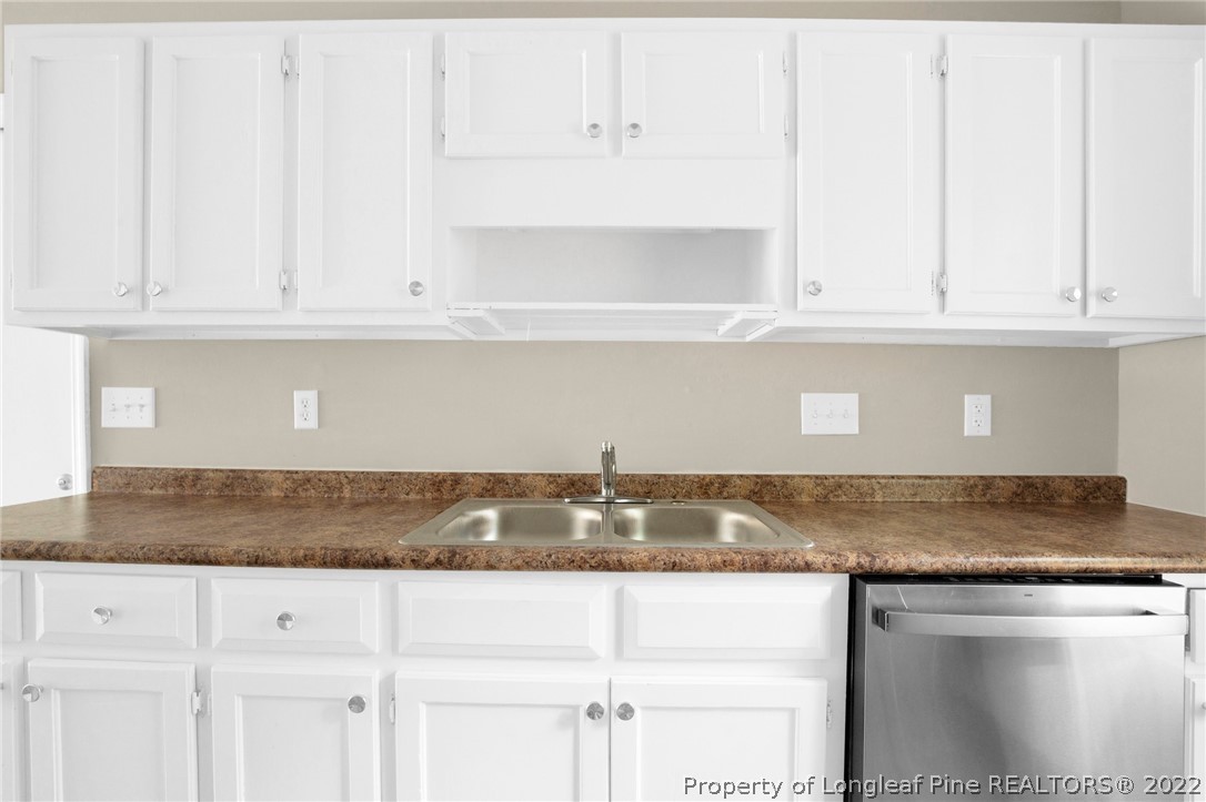 512 Andover Road Fayetteville, NC 28311 - Photo 8 of 18 a kitchen with granite countertop white cabinets and a sink