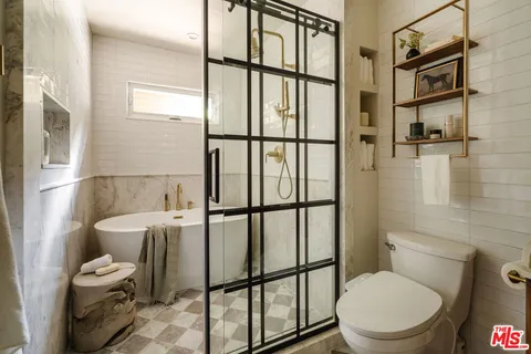 a bathroom with a toilet a sink and a shower
