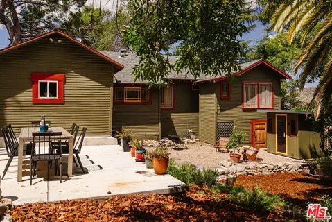 a view of backyard of house with outdoor seating
