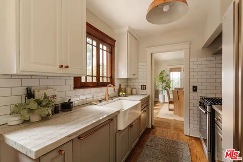 a kitchen with stainless steel appliances granite countertop a sink stove and cabinets