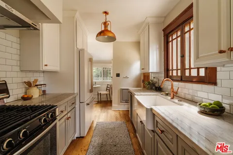 a kitchen with a sink stove and cabinets
