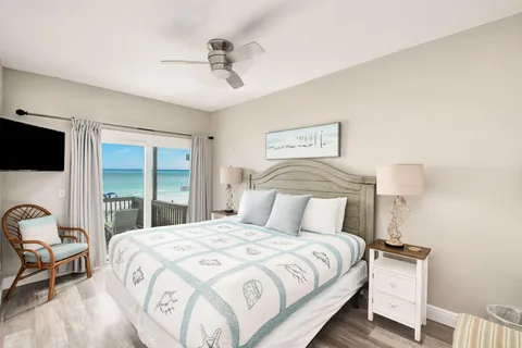 a bedroom with a large bed and a tv