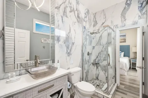 a bathroom with a sink toilet a mirror and shower