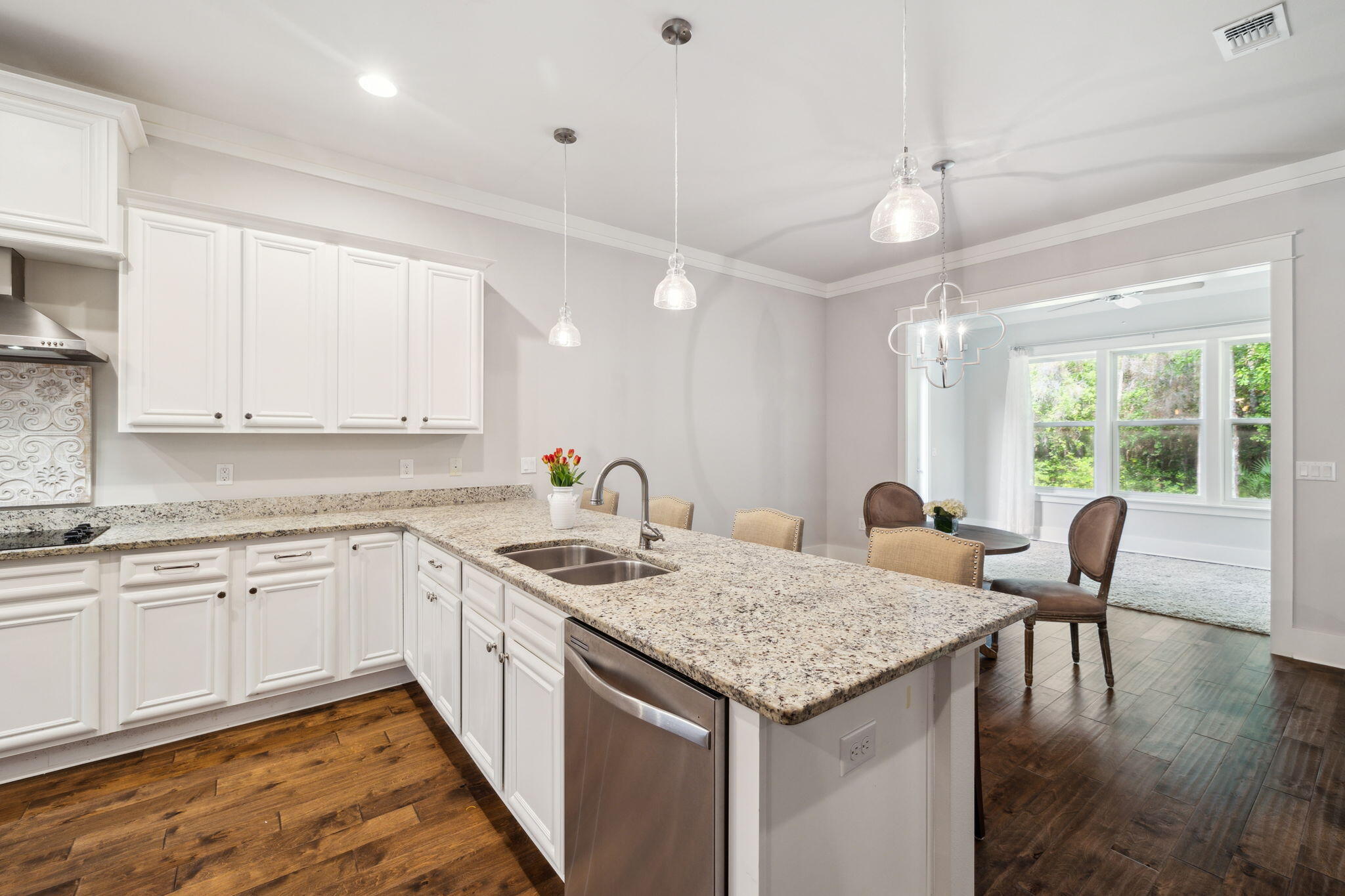 180 Blakely Drew Boulevard Santa Rosa Beach, FL 32459 - Photo 16 of 40 a kitchen with granite countertop kitchen island a center island a sink cabinets and wooden floor