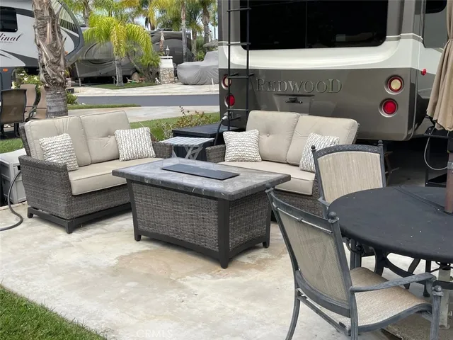 a view of outdoor sitting area with furniture and wooden floor