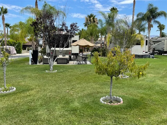 a view of a chairs and table in the yard