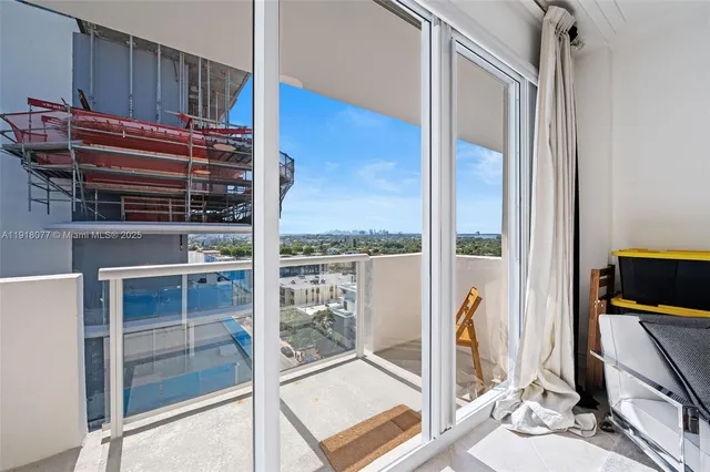 a view of a balcony and a floor to ceiling window