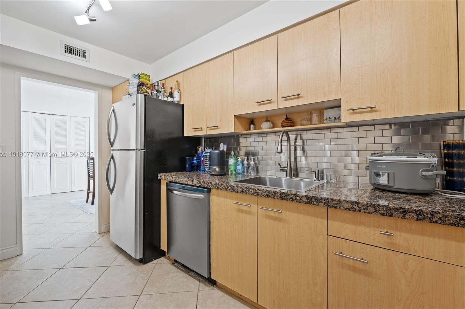9195 Collins Avenue, Unit PH14 Surfside, FL 33154 - Photo 7 of 26 a kitchen with stainless steel appliances granite countertop a refrigerator sink and cabinets