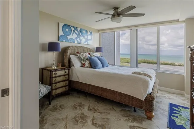 a bedroom with a bed and a large window