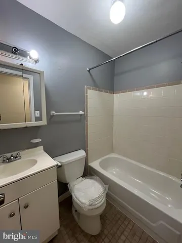 a bathroom with a toilet sink and shower