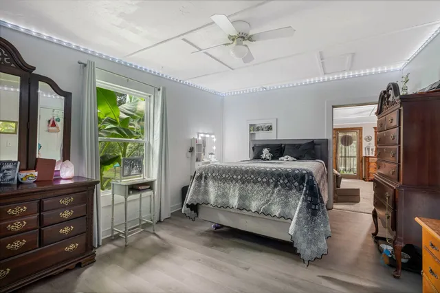 a dining room with kitchen island a wooden floor and chandelier