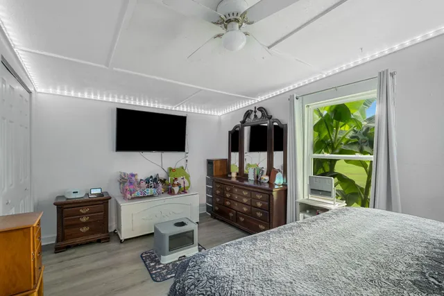 a kitchen with a dining table chairs stainless steel appliances and cabinets