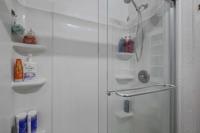 a bedroom with a bed closet and a large window