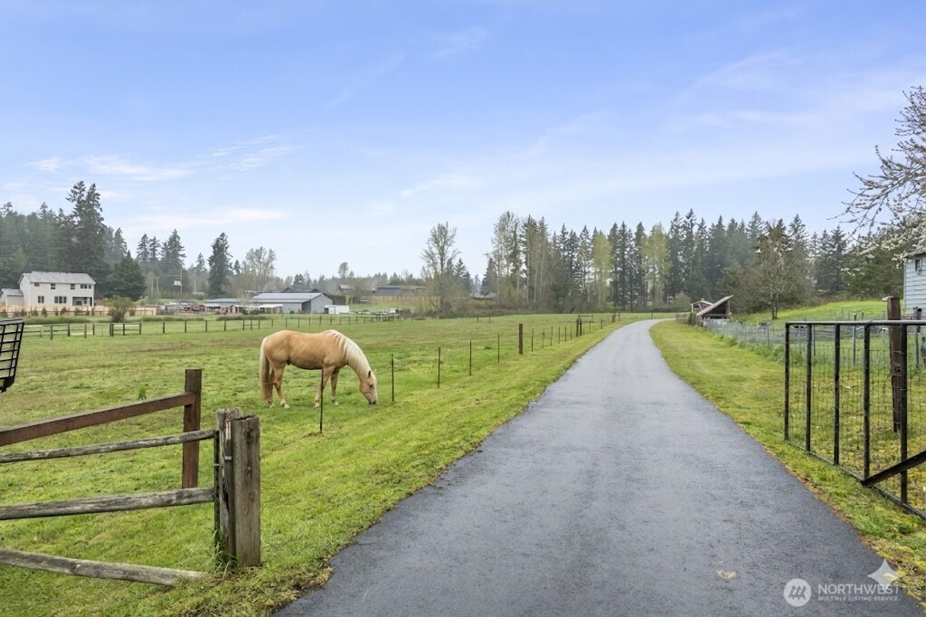 18222 Southeast Wax Road Covington, WA 98042 - Photo 1 of 37 a view of a lake with a big yard and a large trees