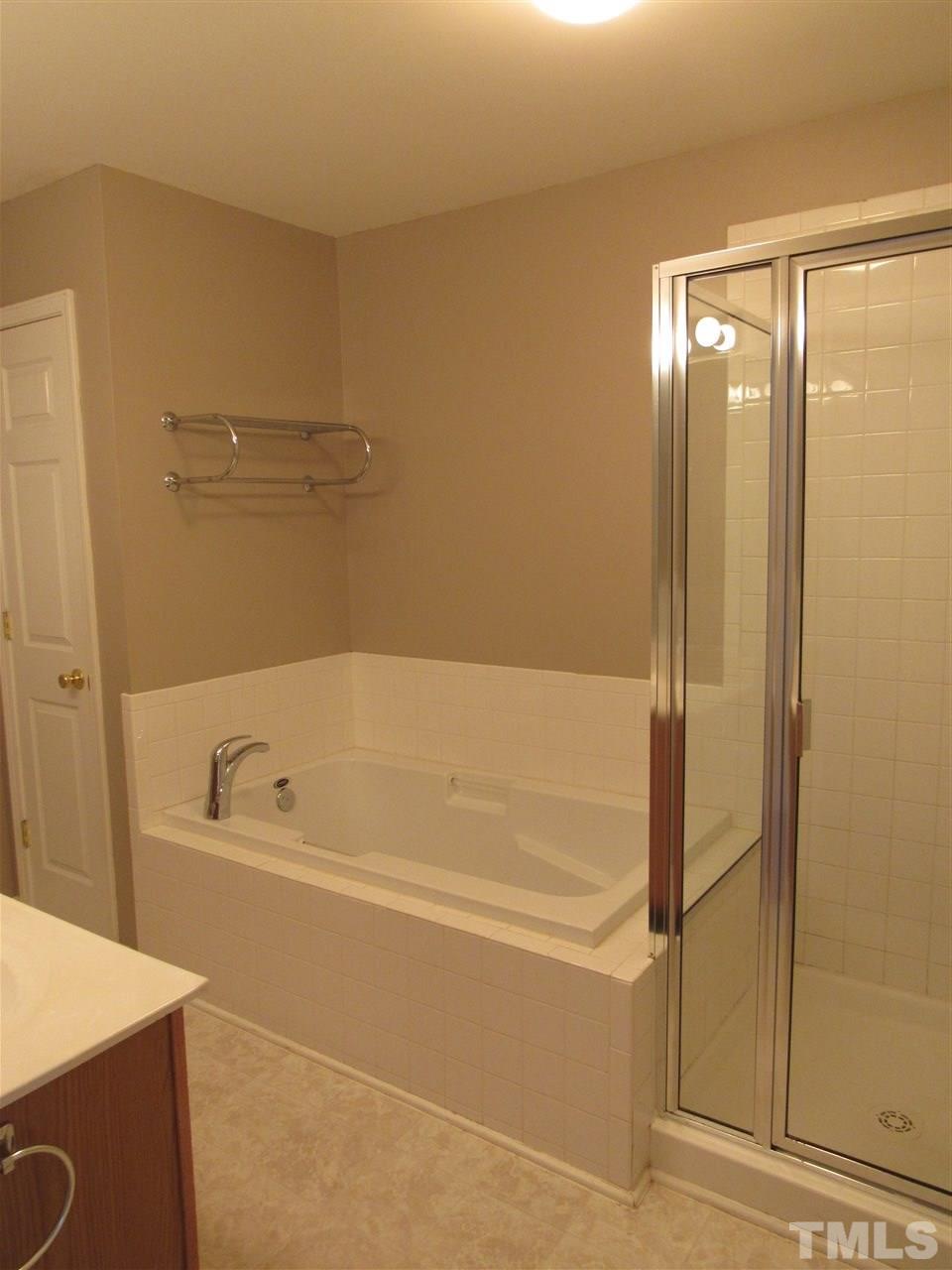 8620 Neuse Landing Lane, Unit 101 Raleigh, NC 27616 - Photo 11 of 16 a bathroom with a bathtub and a shower