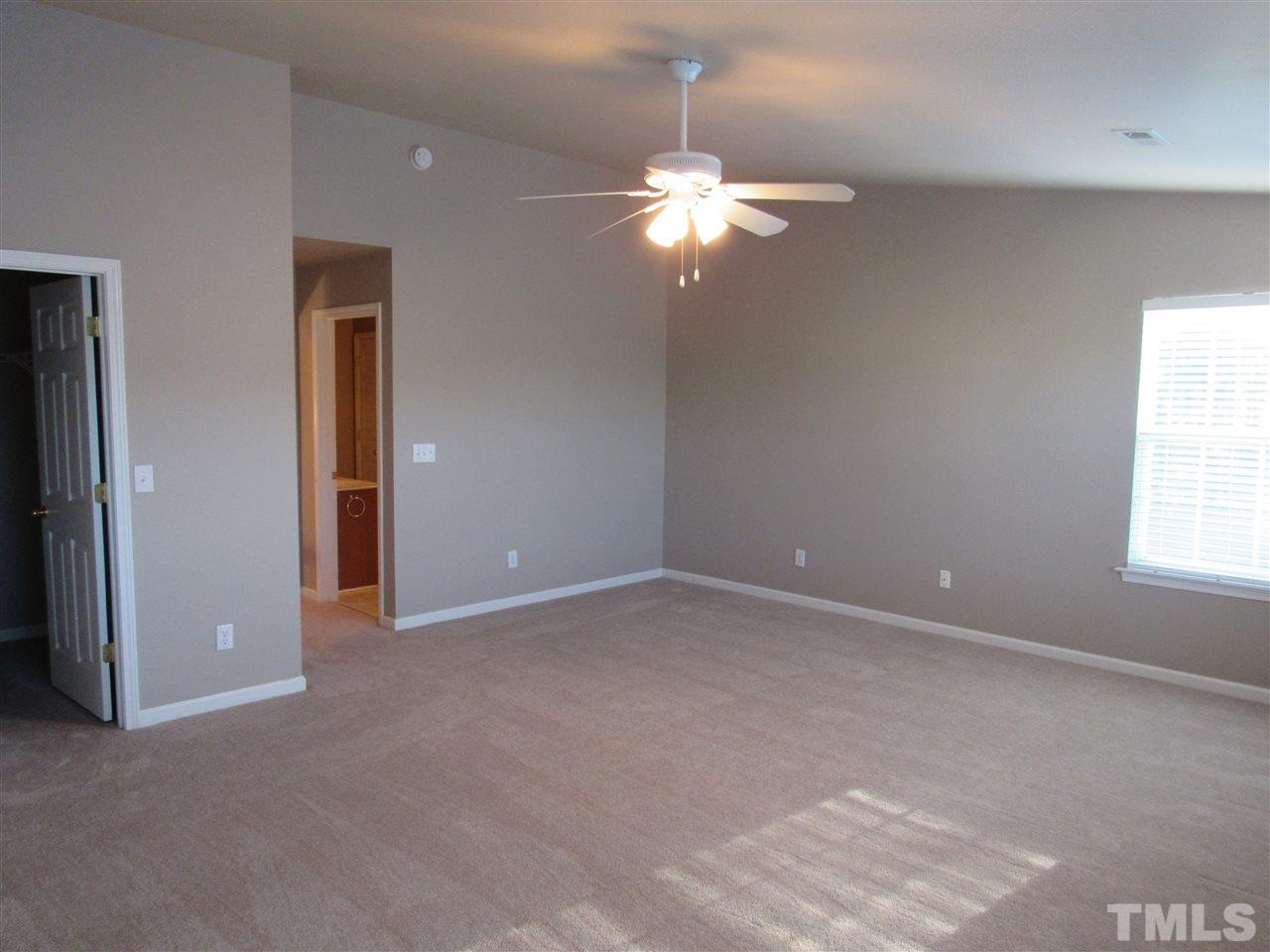 8620 Neuse Landing Lane, Unit 101 Raleigh, NC 27616 - Photo 13 of 16 a view of an empty room with a chandelier fan