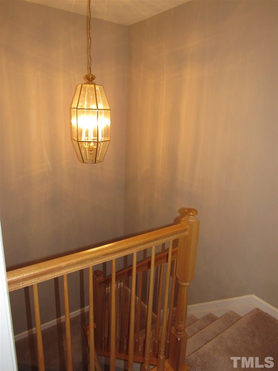8620 Neuse Landing Lane, Unit 101 Raleigh, NC 27616 - Photo 15 of 16 a view of wooden floor and chandelier in a bathroom