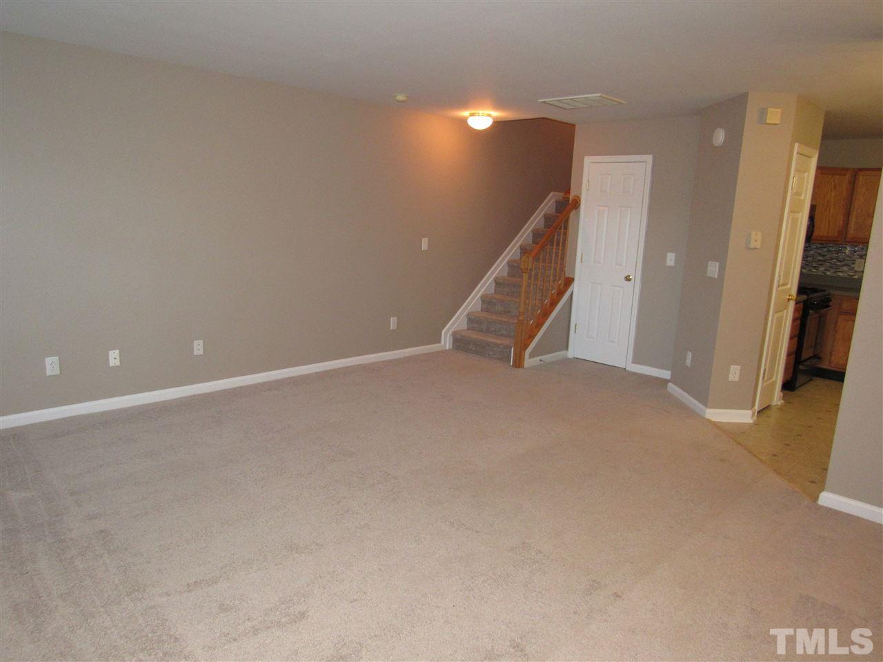 8620 Neuse Landing Lane, Unit 101 Raleigh, NC 27616 - Photo 16 of 16 a view of an empty room with a fireplace