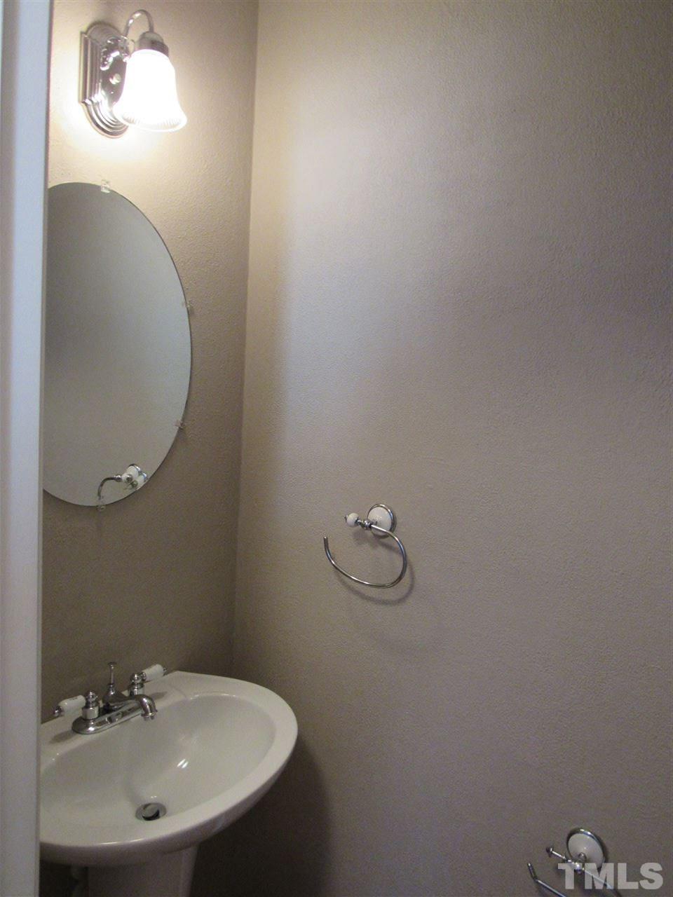 8620 Neuse Landing Lane, Unit 101 Raleigh, NC 27616 - Photo 7 of 16 a bathroom with a sink and mirror