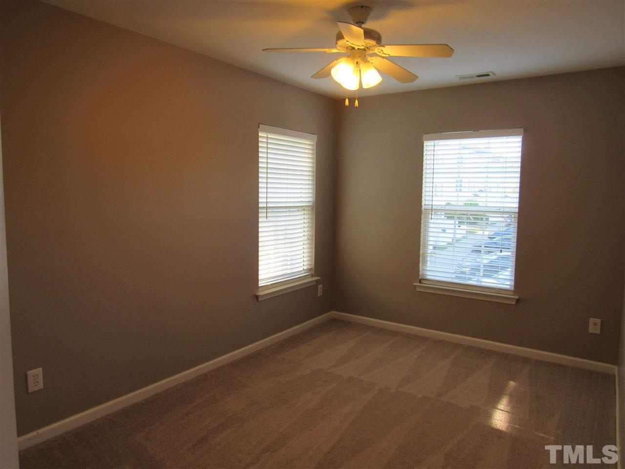 8620 Neuse Landing Lane, Unit 101 Raleigh, NC 27616 - Photo 8 of 16 a view of an empty room with a window