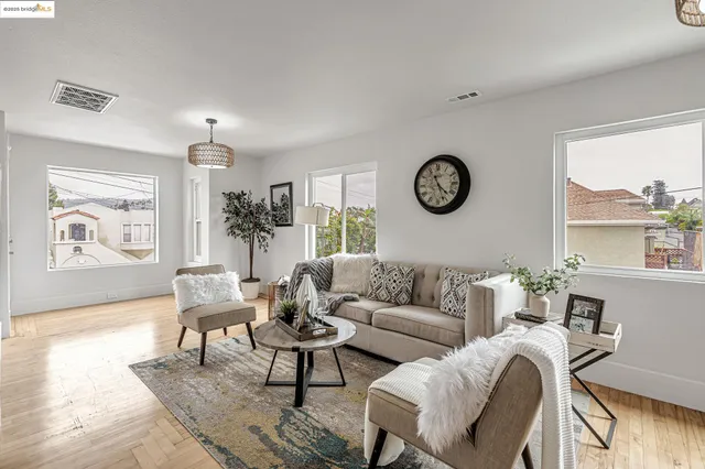 a living room with furniture a clock and a window