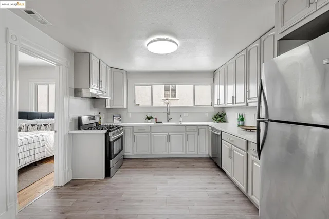 a kitchen with white cabinets and white appliances