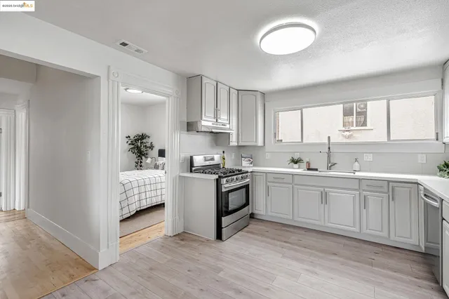 a kitchen with white cabinets and a sink