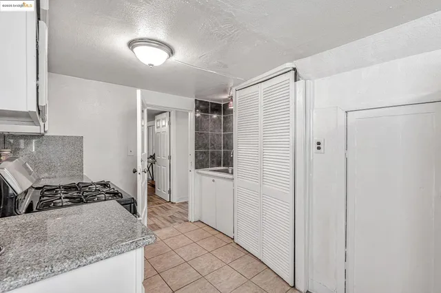 a kitchen with stainless steel appliances granite countertop a refrigerator and a stove