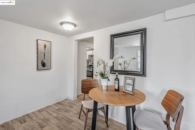 a view of a room with furniture and wooden floor