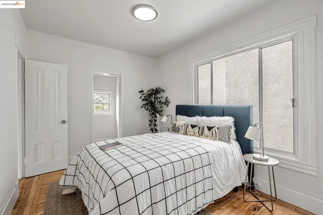 a bedroom with a bed and a window