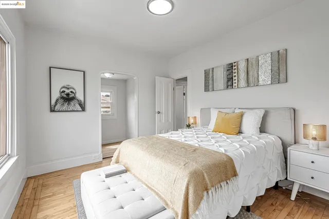 a bedroom with a bed and painting on the wall