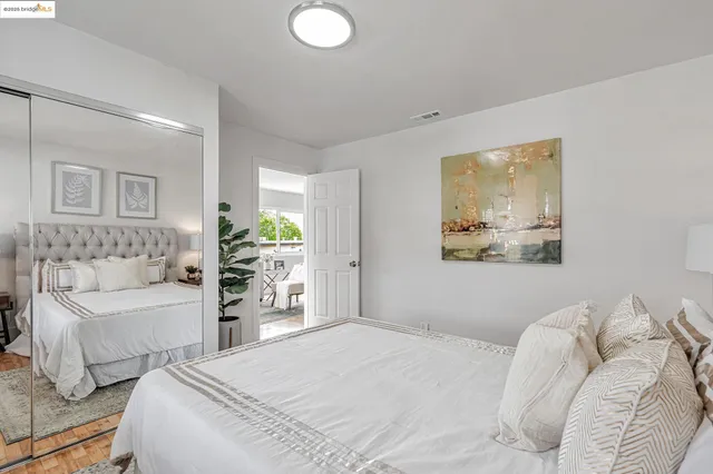 a bedroom with a bed and a couch