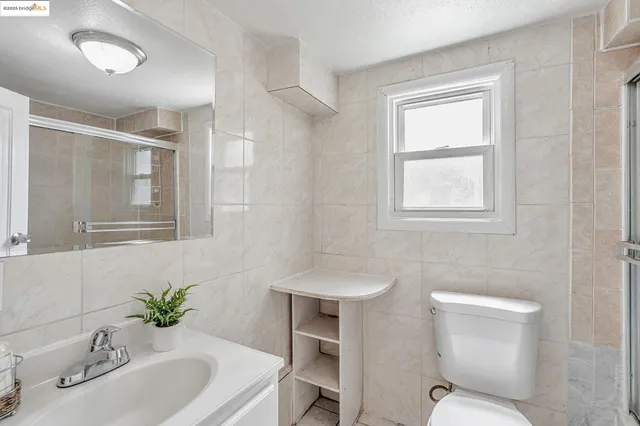 a bathroom with a sink toilet and a mirror